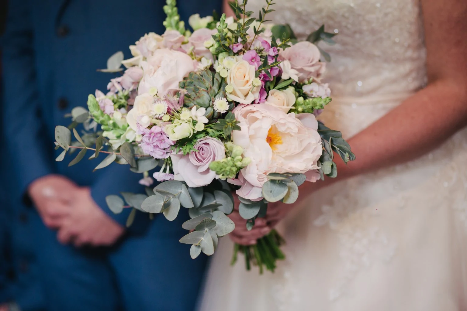 Couple holding wedding bouquet